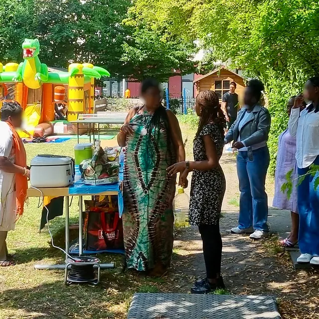 An einem Tisch stehen Menschen der presbyterianischen Gemeinde.